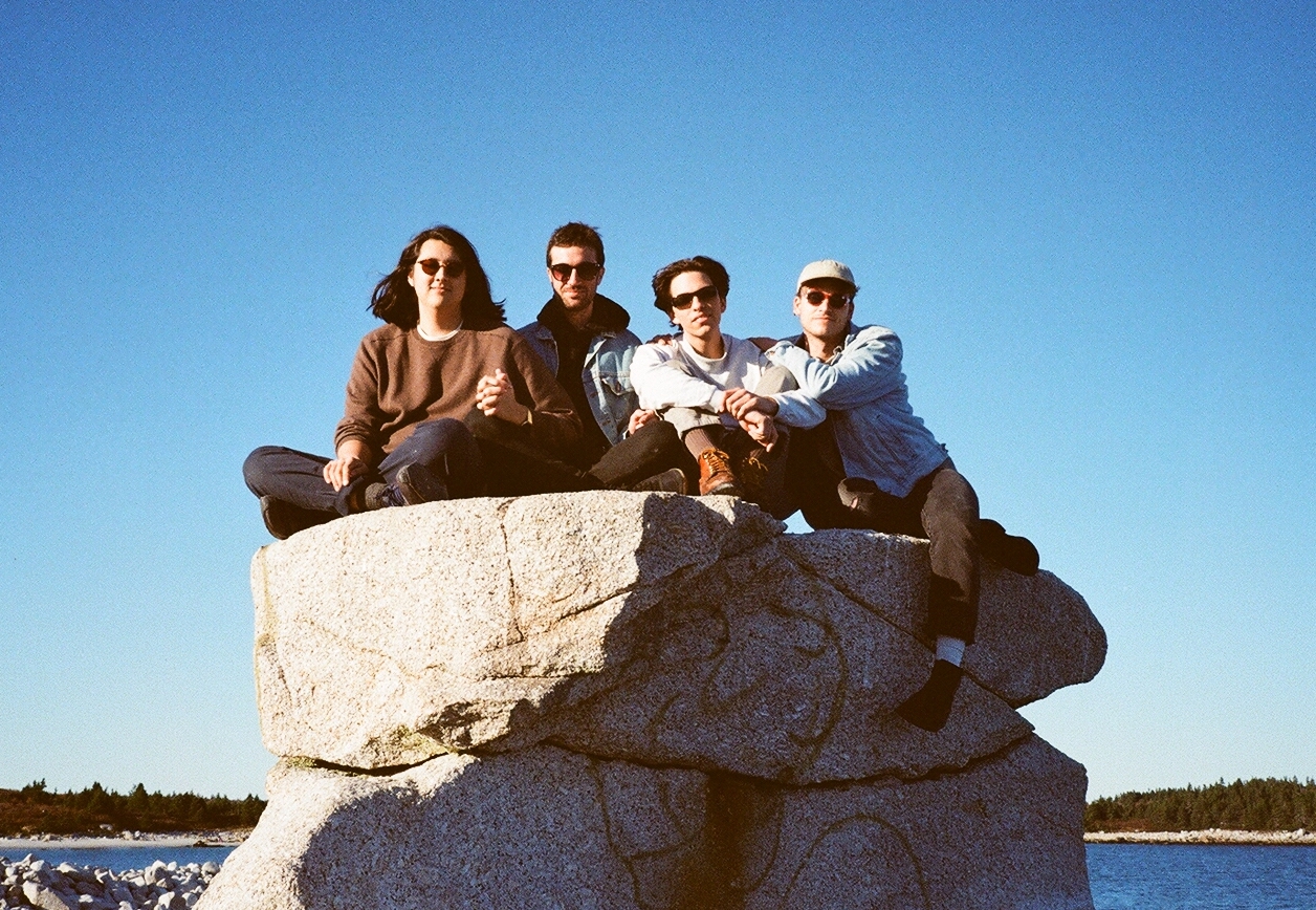Versing sitting on a rock in Halifax, NS